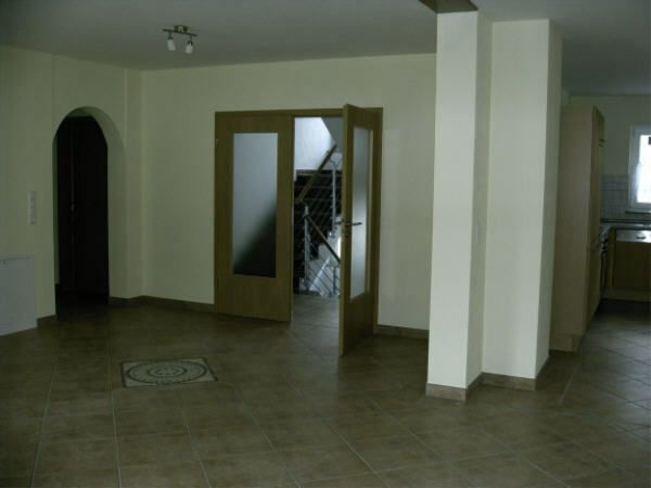 The living room on the 1st floor (41.4sqm incl. kitchen). 
On the right you can see a part of the kitchen, it is open to the living room.
On the left your can go to the bathroom, a small storeroom and to one bedroom