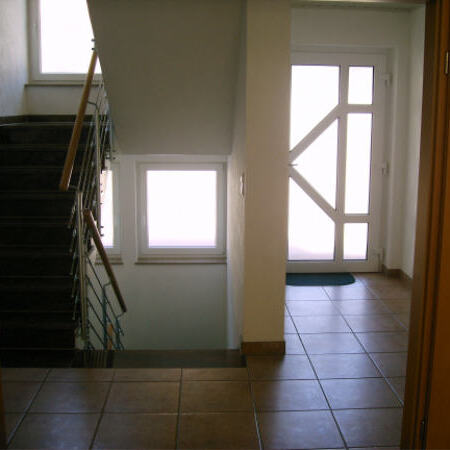 Main entry and stairwell to the basement and top floor